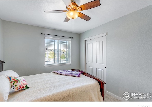 carpeted bedroom featuring baseboards, ceiling fan, and a closet