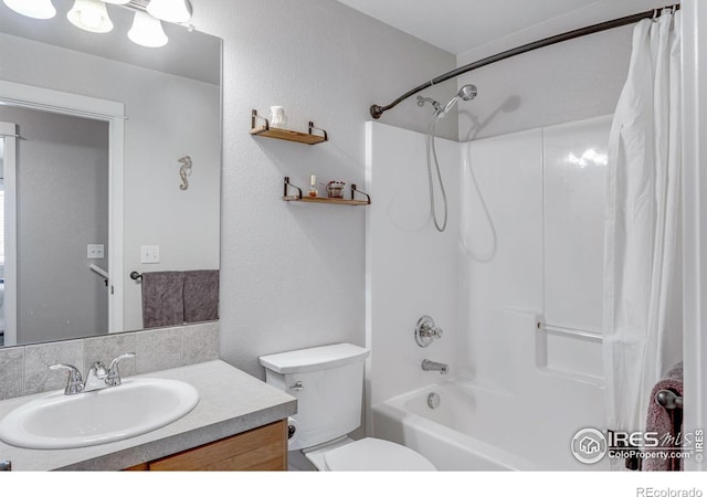 bathroom with vanity, shower / tub combo with curtain, and toilet