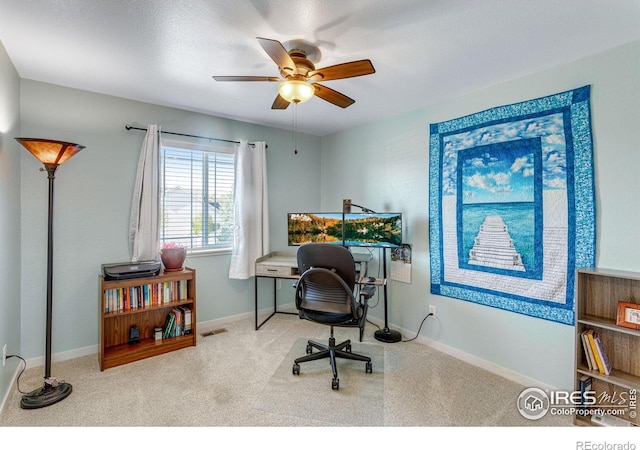 office area featuring a ceiling fan, carpet floors, and baseboards