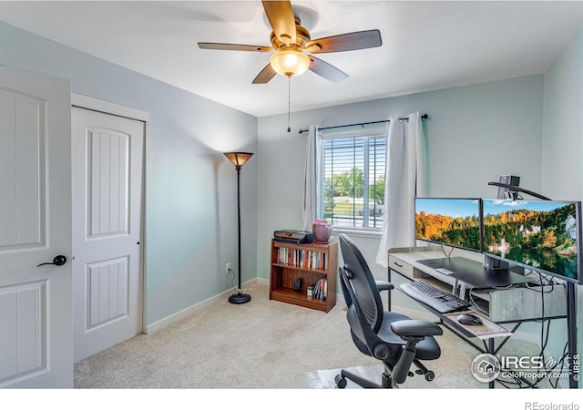 home office with carpet flooring, ceiling fan, and baseboards