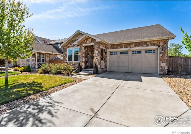 view of front of property featuring stone siding, a garage, driveway, and a shingled roof