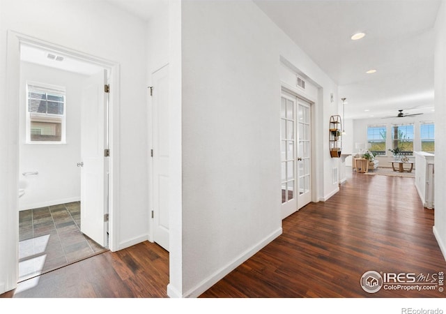hall with wood finished floors, recessed lighting, baseboards, and french doors