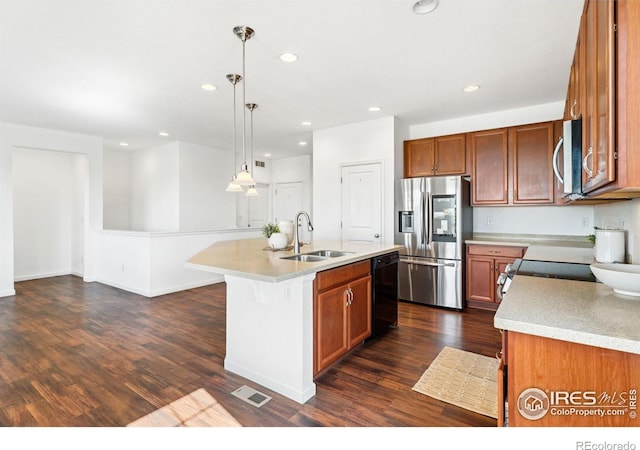 kitchen with appliances with stainless steel finishes, a sink, light countertops, dark wood-style floors, and recessed lighting