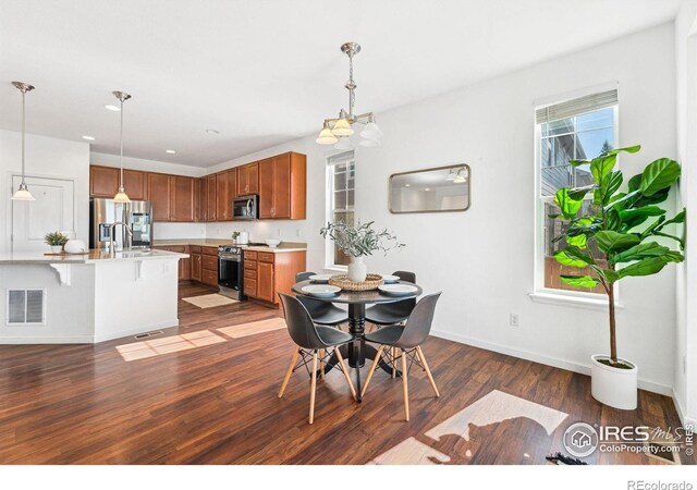 dining space with dark wood-style floors and baseboards