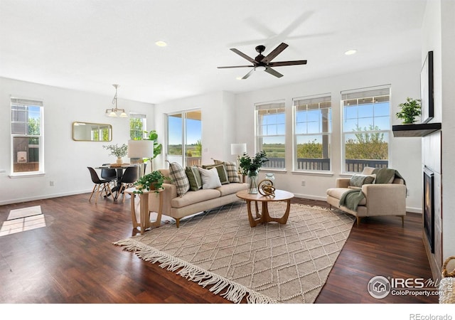 living room featuring wood finished floors, baseboards, a ceiling fan, recessed lighting, and a fireplace