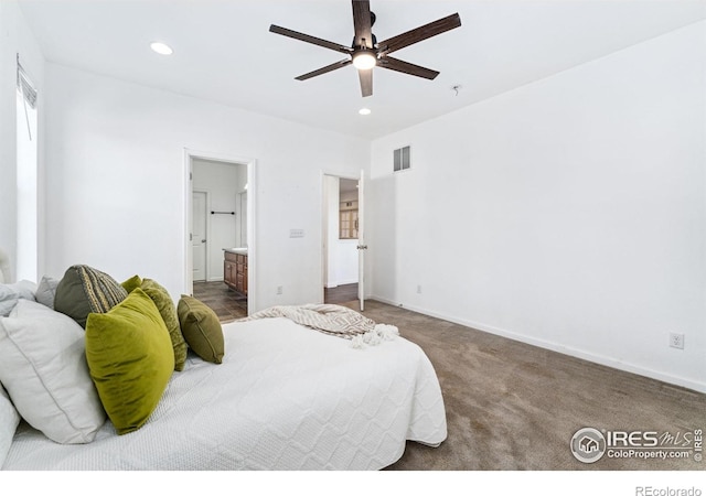 carpeted bedroom with recessed lighting, baseboards, ensuite bathroom, and a ceiling fan