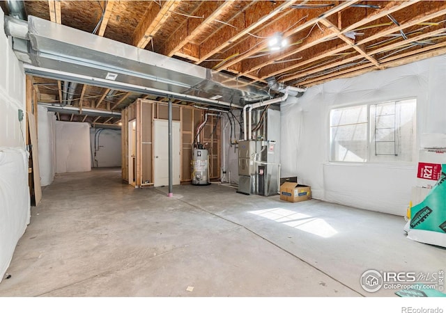 below grade area featuring heating unit and gas water heater