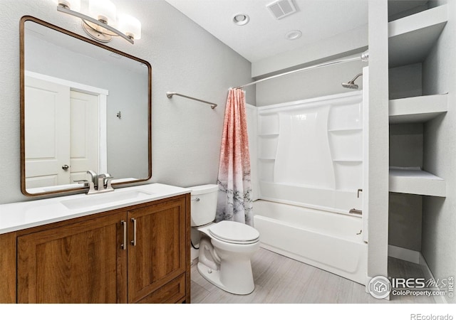bathroom with toilet, vanity, and shower / tub combo