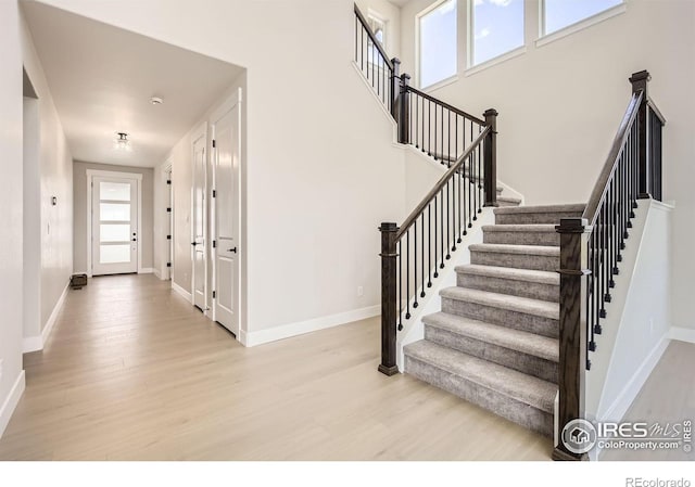 1679 Crystalline Dr, Windsor, CO 80550 - staircase with wood finished floors and baseboards
