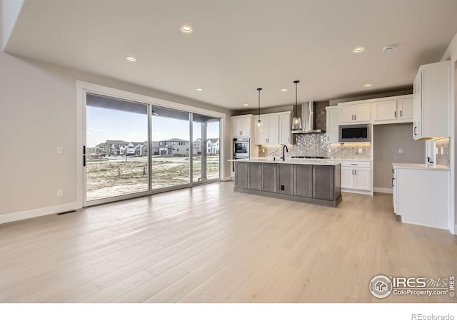 1679 Crystalline Dr, Windsor, CO 80550 - kitchen with wall chimney range hood, white cabinetry, light wood-style floors, light countertops, and decorative backsplash