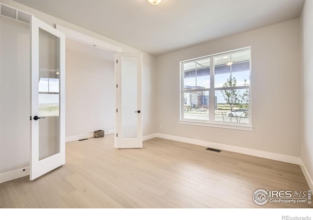 1679 Crystalline Dr, Windsor, CO 80550 - unfurnished room with french doors, baseboards, and light wood-style floors