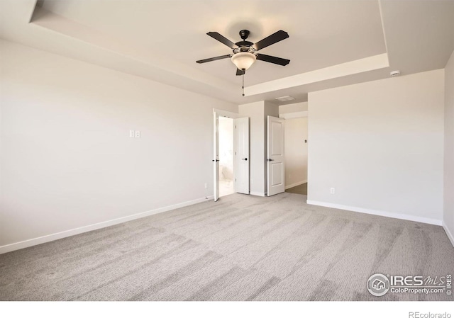 1679 Crystalline Dr, Windsor, CO 80550 - unfurnished room featuring a raised ceiling, carpet floors, ceiling fan, and baseboards
