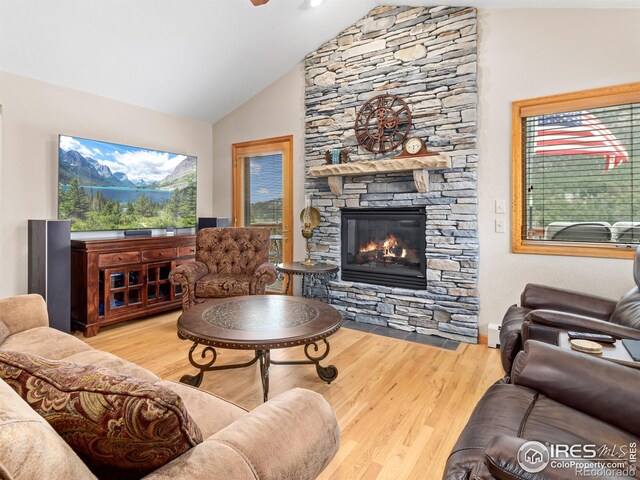 658 Cedar Ridge Cir, Estes Park, CO 80517 - living area featuring a fireplace, wood finished floors, a baseboard heating unit, and high vaulted ceiling
