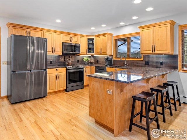 658 Cedar Ridge Cir, Estes Park, CO 80517 - kitchen with stainless steel appliances, a sink, light wood finished floors, dark stone counters, and recessed lighting