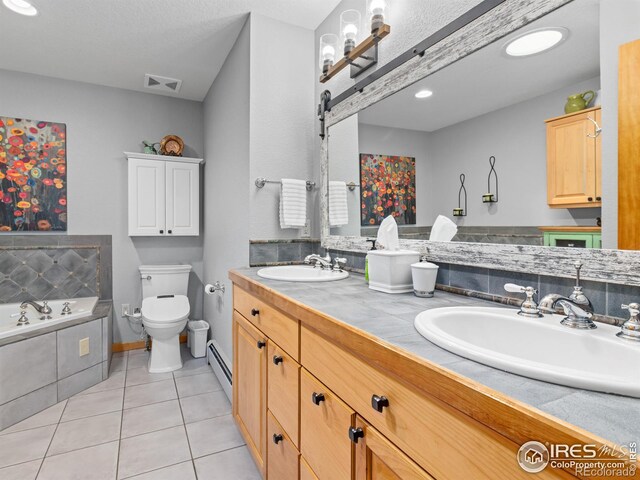 658 Cedar Ridge Cir, Estes Park, CO 80517 - full bath featuring baseboard heating, tile patterned flooring, toilet, a garden tub, and double vanity