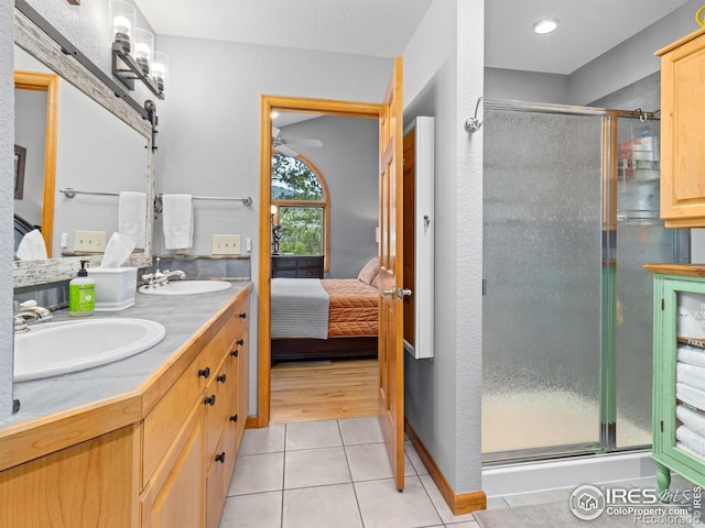 658 Cedar Ridge Cir, Estes Park, CO 80517 - bathroom with a stall shower, ensuite bathroom, tile patterned flooring, and double vanity