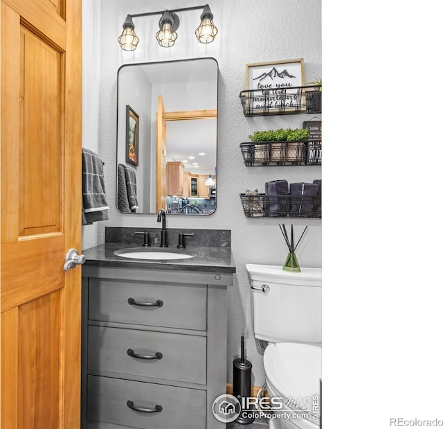 658 Cedar Ridge Cir, Estes Park, CO 80517 - half bath with a textured wall, toilet, and vanity