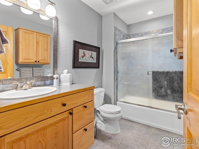 658 Cedar Ridge Cir, Estes Park, CO 80517 - full bathroom with tile patterned floors, vanity, toilet, and combined bath / shower with glass door
