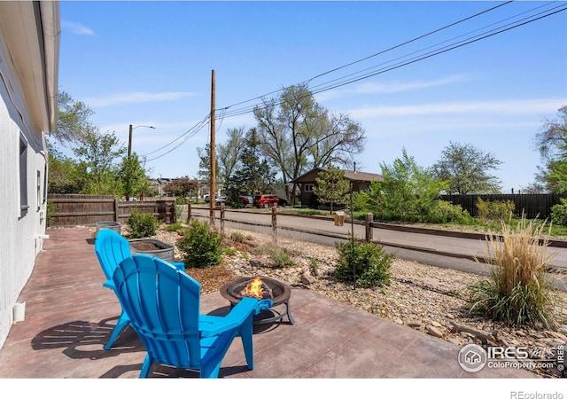 view of patio with an outdoor fire pit and a fenced backyard