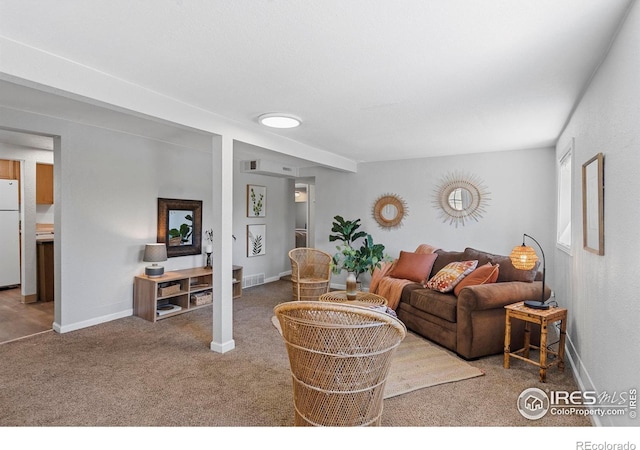 carpeted living area featuring baseboards
