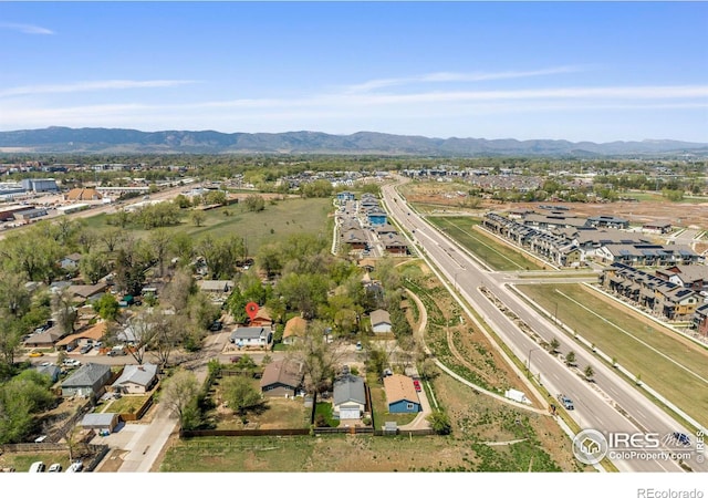 aerial perspective of suburban area with a major roadway and mountains
