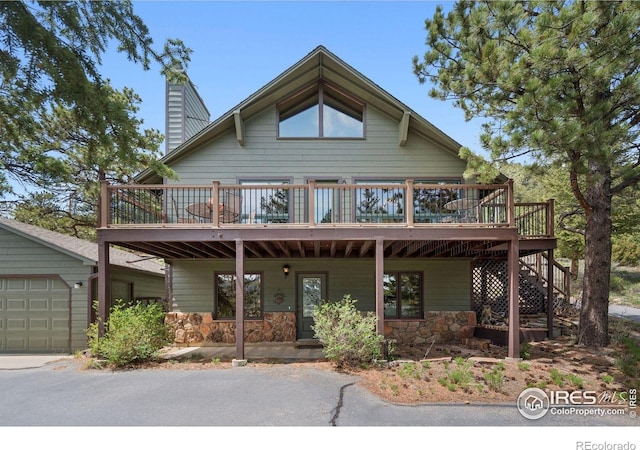 1433 Vista View Ln, Estes Park, CO 80517 - view of front facade featuring a deck, a chimney, stone siding, and stairway