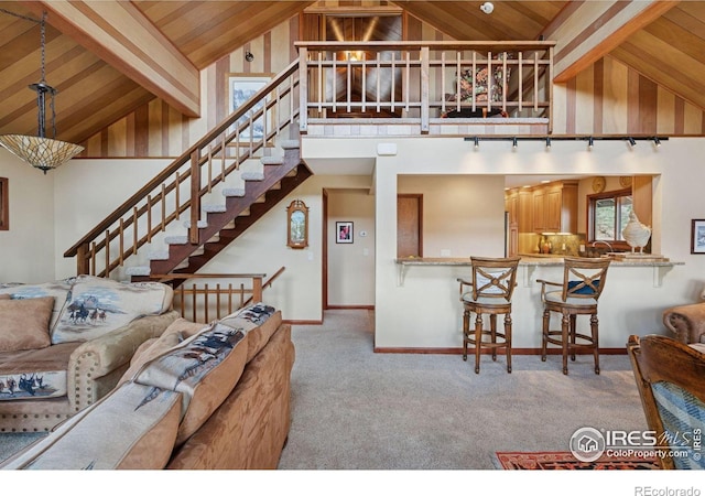 1433 Vista View Ln, Estes Park, CO 80517 - living room featuring wood ceiling, carpet flooring, stairs, beam ceiling, and baseboards