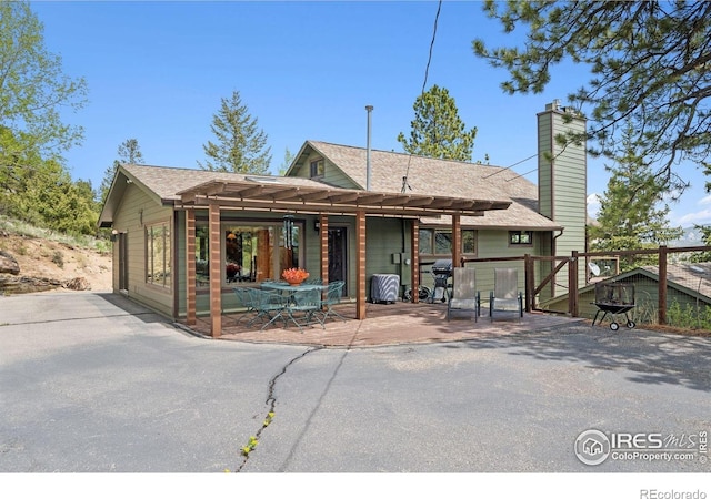1433 Vista View Ln, Estes Park, CO 80517 - back of property featuring a patio and a chimney