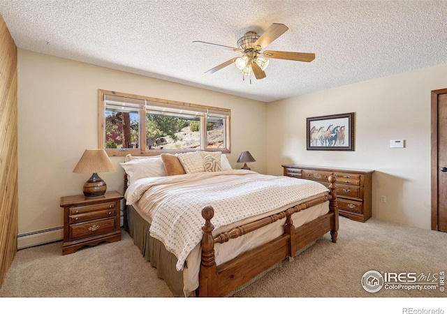 1433 Vista View Ln, Estes Park, CO 80517 - bedroom featuring baseboard heating, light colored carpet, a textured ceiling, and ceiling fan