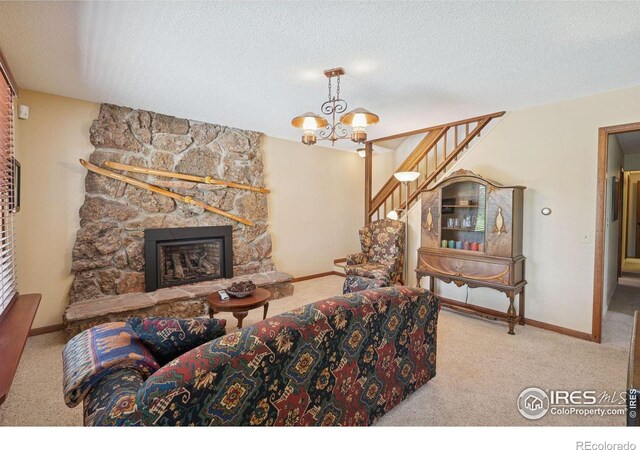 1433 Vista View Ln, Estes Park, CO 80517 - carpeted living room with baseboards, a textured ceiling, a chandelier, stairway, and a stone fireplace