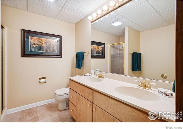1433 Vista View Ln, Estes Park, CO 80517 - bathroom featuring a paneled ceiling, a shower stall, baseboards, double vanity, and toilet
