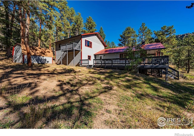 31 Cedar Dr, Lyons, CO 80540 - view of grassy yard featuring stairs, a wooden deck, and an outdoor structure