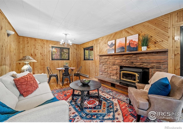 31 Cedar Dr, Lyons, CO 80540 - living room featuring wooden walls, a chandelier, wood finished floors, and a fireplace