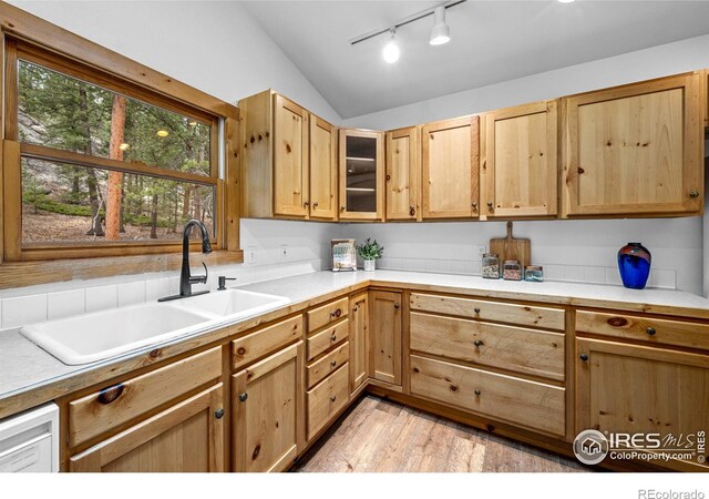 31 Cedar Dr, Lyons, CO 80540 - kitchen with lofted ceiling, a sink, track lighting, light wood-style floors, and light countertops