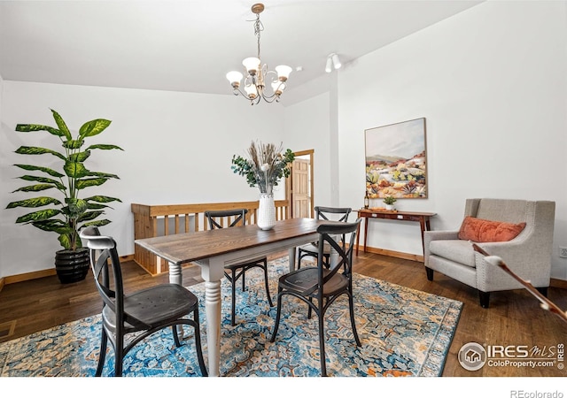 31 Cedar Dr, Lyons, CO 80540 - dining area featuring a chandelier, wood finished floors, and baseboards