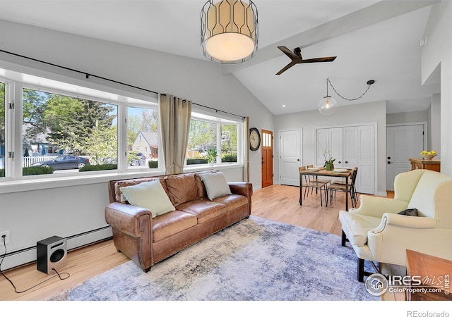 living room featuring wood finished floors, a ceiling fan, and a baseboard heating unit