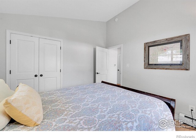 bedroom with a closet, baseboard heating, and baseboards