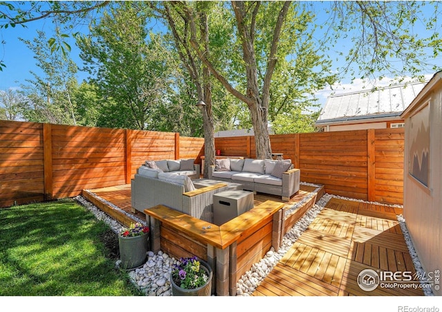 wooden terrace featuring outdoor lounge area and a fenced backyard