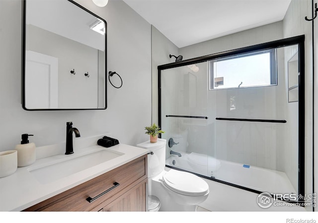 full bath featuring toilet, vanity, and enclosed tub / shower combo
