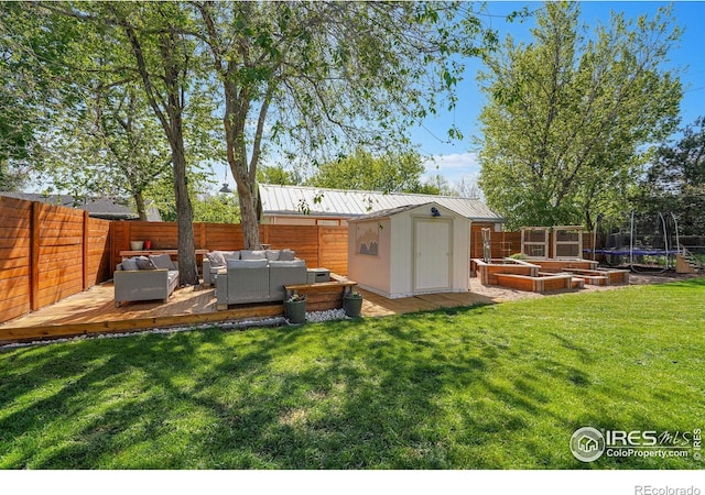 view of shed featuring an outdoor living space, a trampoline, and a vegetable garden