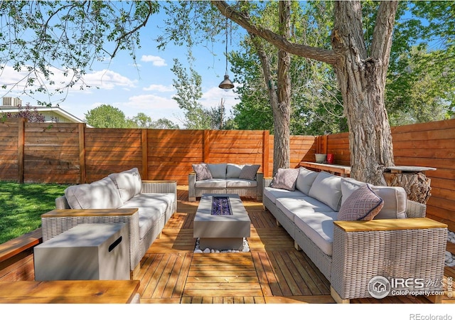 wooden deck featuring outdoor lounge area and a fenced backyard