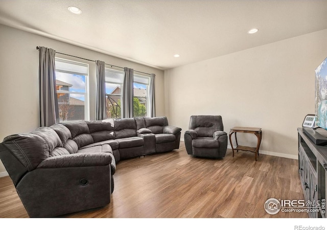 living area featuring wood finished floors, recessed lighting, and baseboards