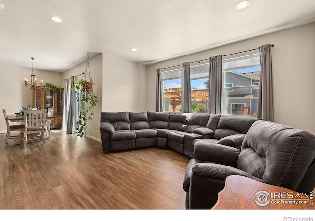 living room featuring a chandelier, wood finished floors, baseboards, and recessed lighting