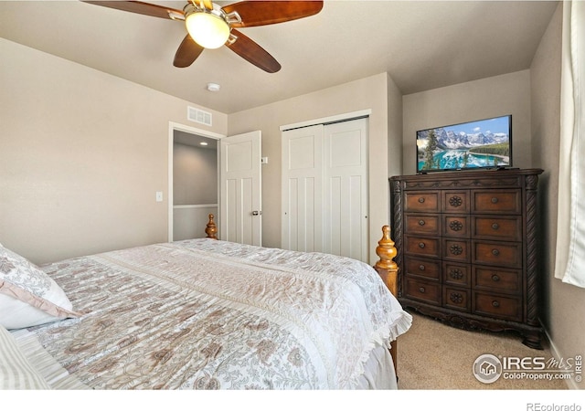 bedroom with carpet floors, a closet, and a ceiling fan