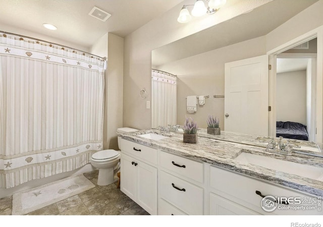 bathroom with toilet, double vanity, and a shower with curtain