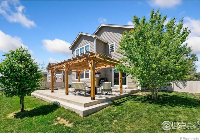 rear view of property with a pergola and a patio