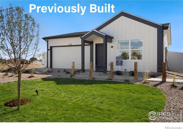 7167 Gateway Crossing St, Wellington, CO 80549 - view of front facade featuring a front yard, a garage, and board and batten siding