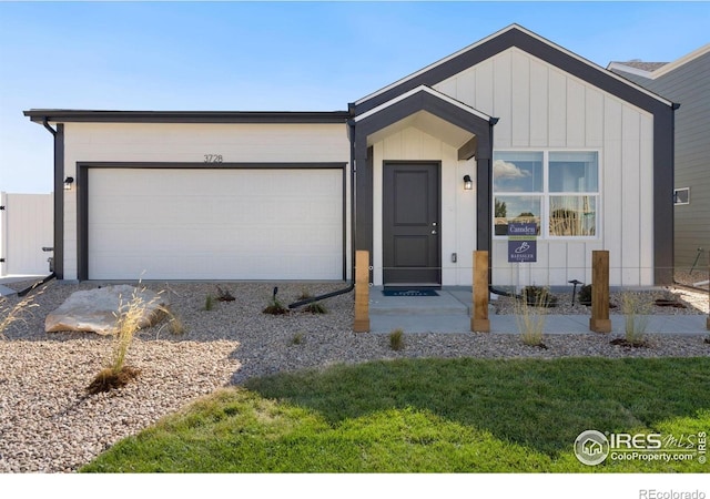7167 Gateway Crossing St, Wellington, CO 80549 - view of front of house featuring an attached garage and board and batten siding