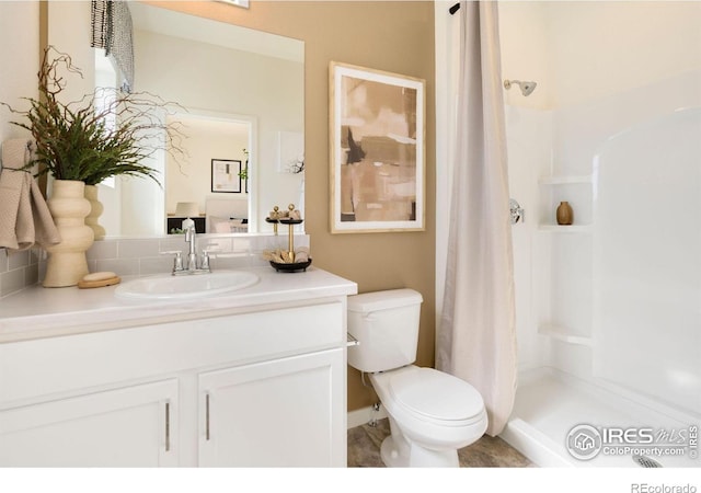 7167 Gateway Crossing St, Wellington, CO 80549 - full bath with toilet, a shower stall, vanity, and decorative backsplash