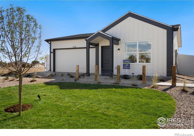 7167 Gateway Crossing St, Wellington, CO 80549 - view of front of home featuring a garage, a front yard, and board and batten siding